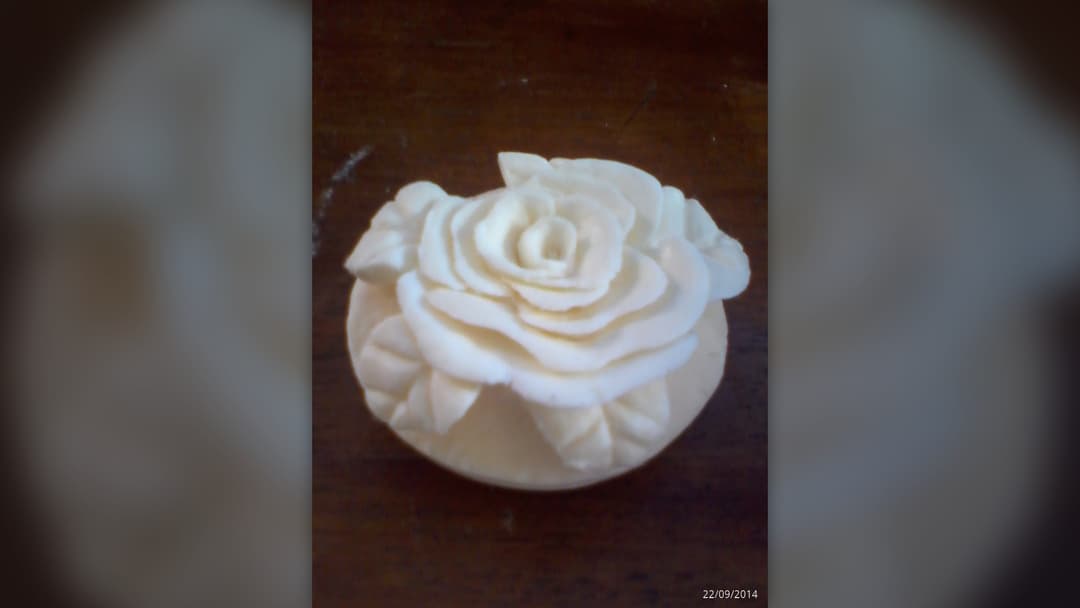 Intricate miniature cat sculpture hand-carved out of a green bar of soap