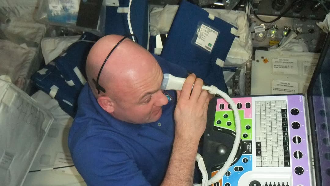 Astronaut Andre Kuipers performing an ultrasound eye imaging examination inside the ISS Columbus laboratory