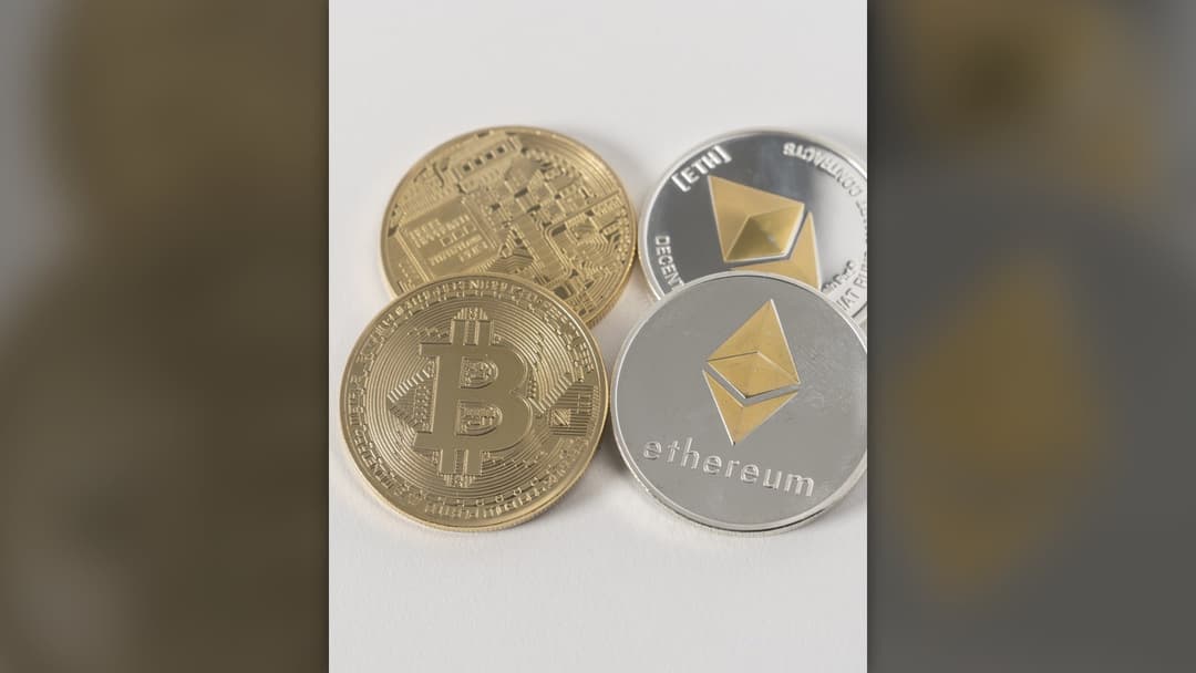 Physical cryptocurrency coins arranged together on a surface