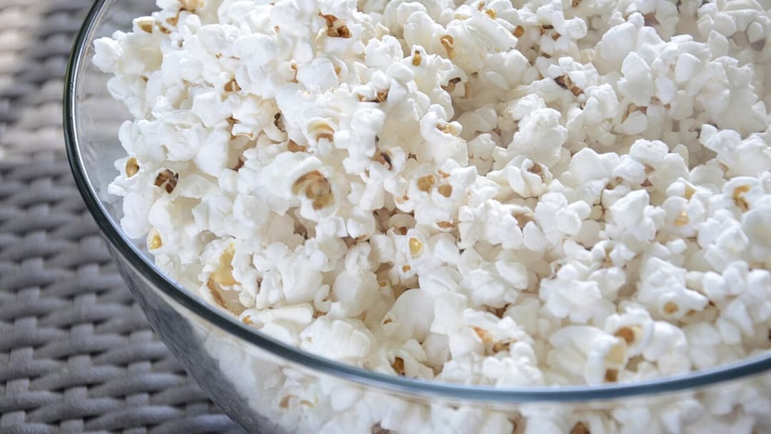 Ceramic bowl filled with fresh warm popped popcorn