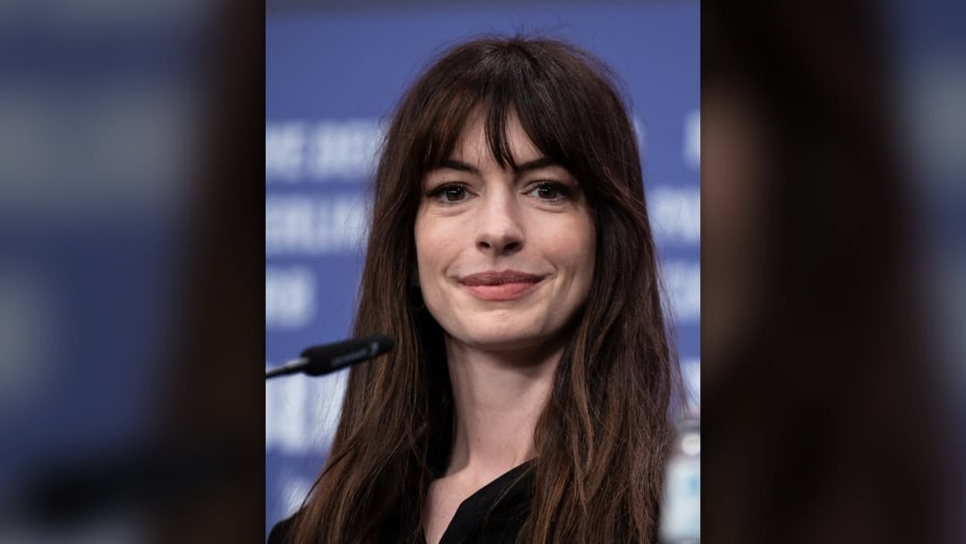 Actress Anne Hathaway smiling at the 2023 Berlin International Film Festival