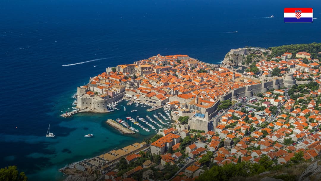 Dubrovnik Old Town fortified walls and turquoise Adriatic sea.