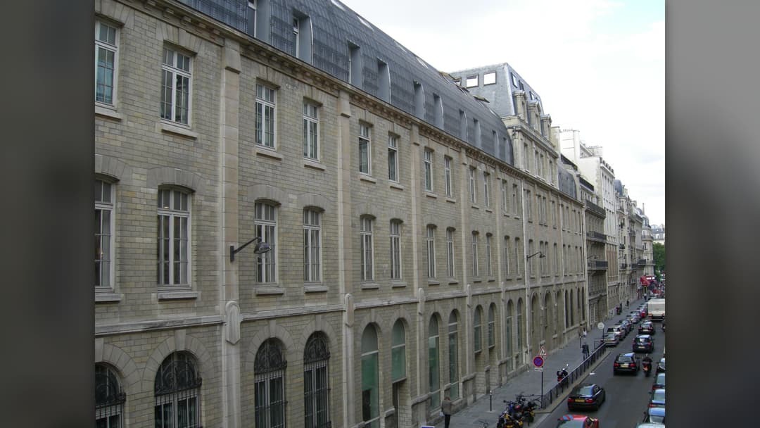Historic stone facade and arched windows of the Conservatoire de Paris in France