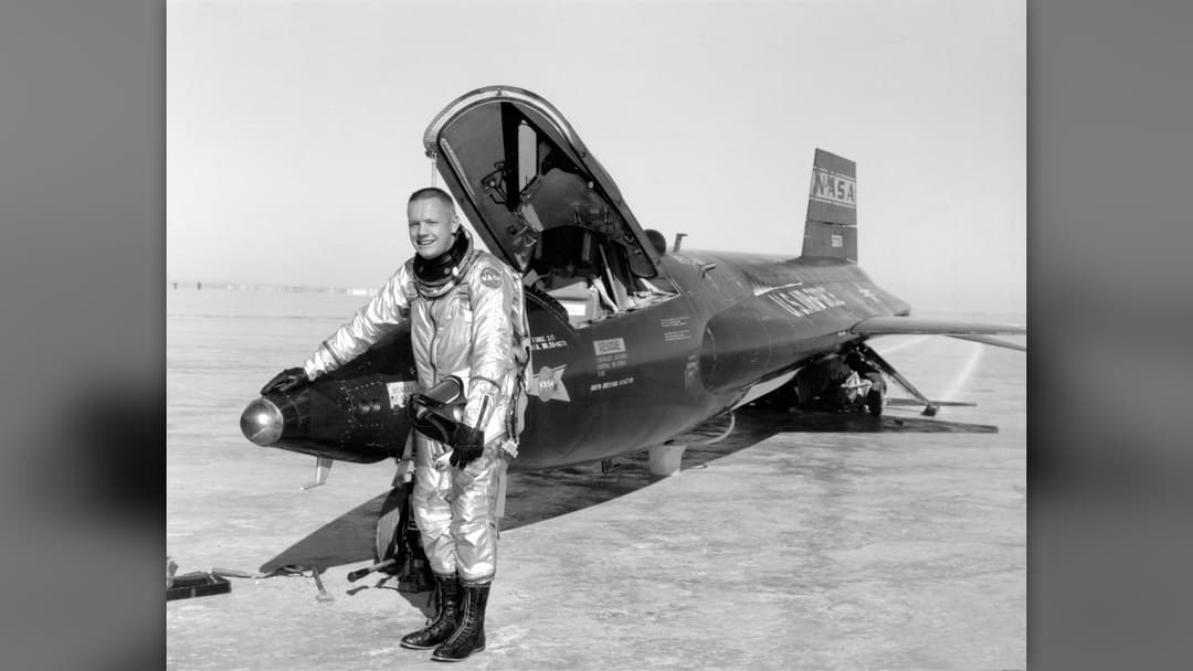 Test pilot Neil Armstrong standing beside the rocket-powered X-15 research aircraft after a high-altitude flight