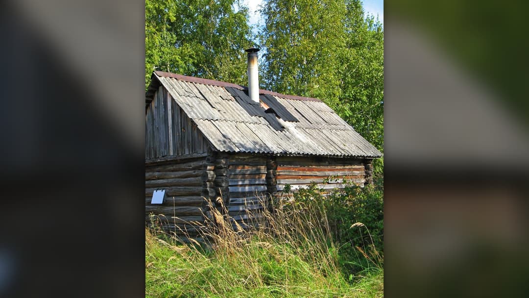 Traditional rustic wooden Russian banya bathhouse cabin in winter