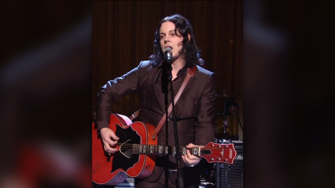 Musician Jack White playing guitar on stage in the East Room of the White House