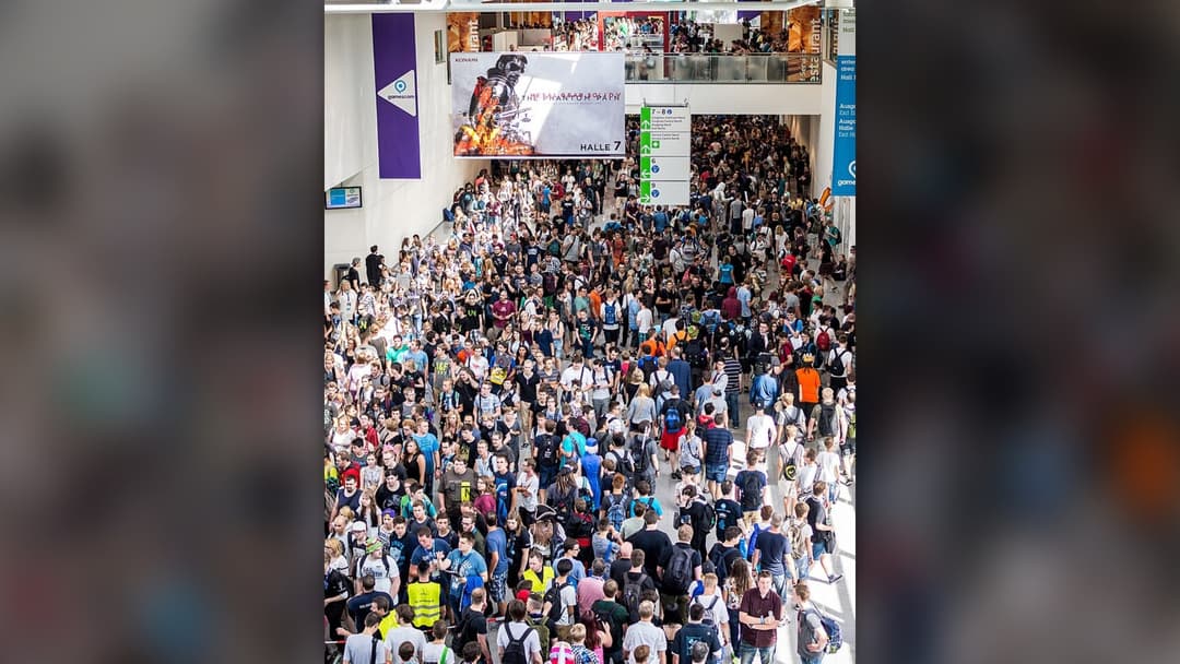 A massive crowd of gamers at a major gaming convention representing the global player community.