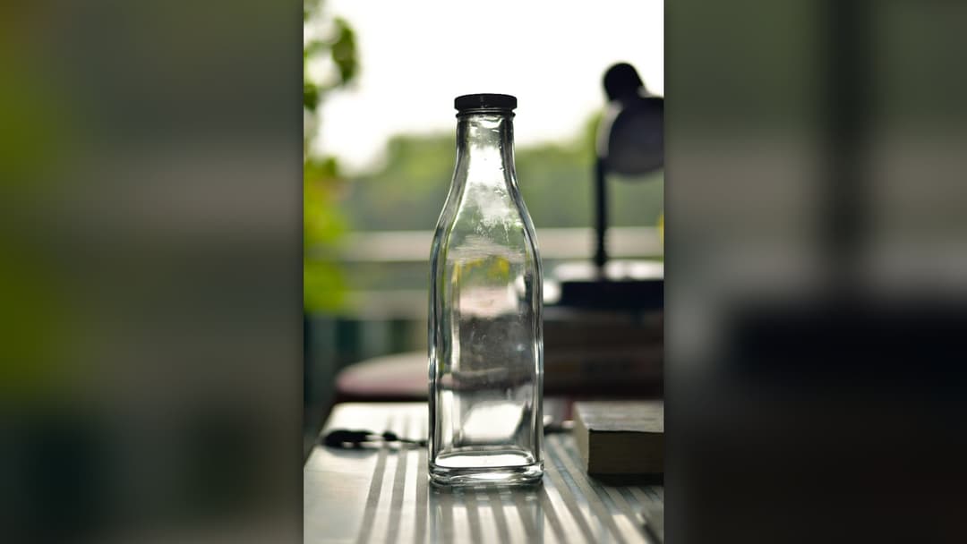 Dining table set with wine and glass bottles in a restaurant