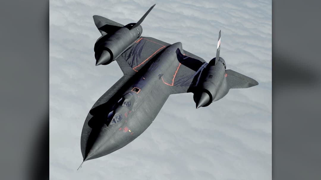 Lockheed SR-71 Blackbird supersonic reconnaissance aircraft flying over snow-covered mountains