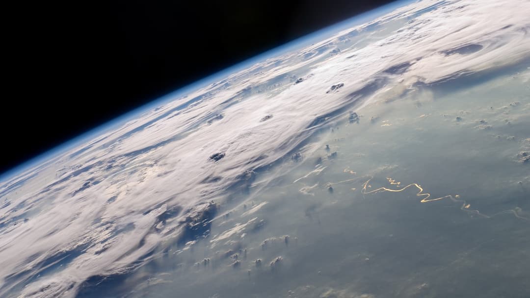 Sunlight glinting across Earth's horizon and atmosphere from low-Earth orbit