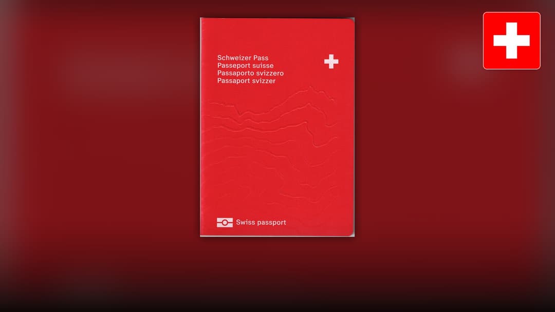 Bright red Swiss passport cover embossed with the white Swiss cross and multi-language titles.
