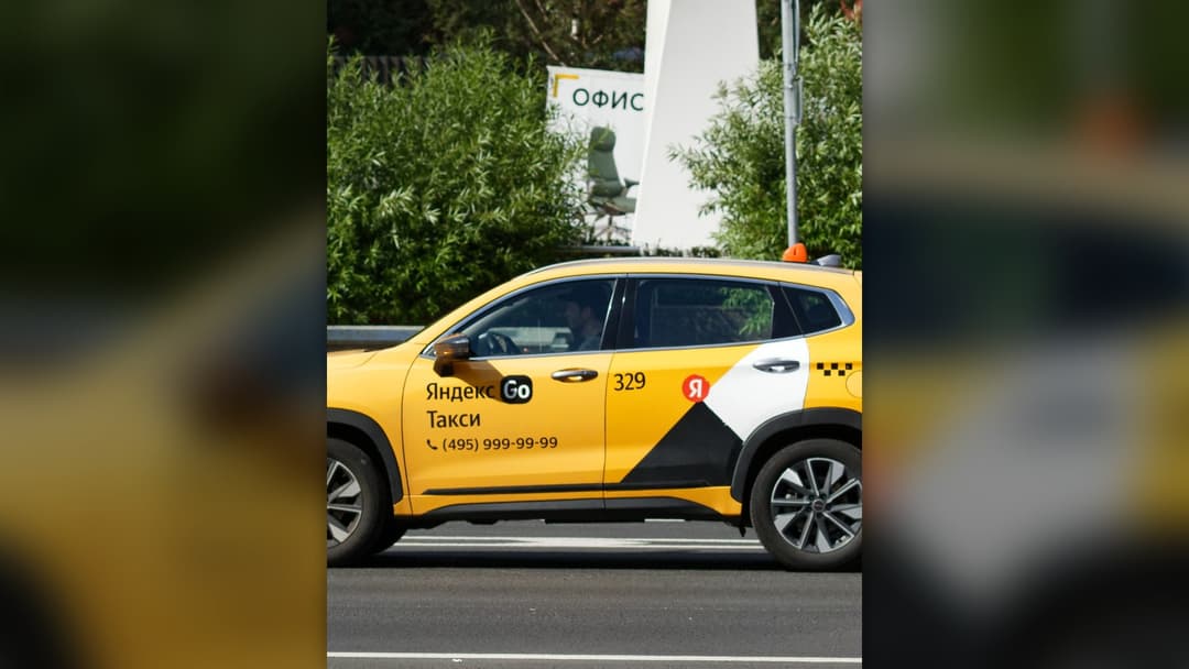 Licensed yellow and white city taxi operating on Moscow roads