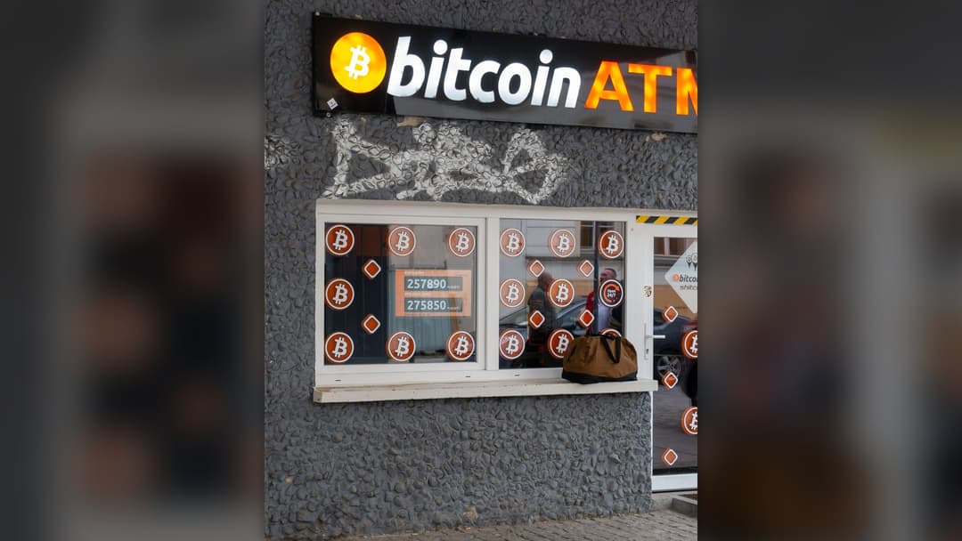 Commemorative golden Bitcoin token displayed on dark background