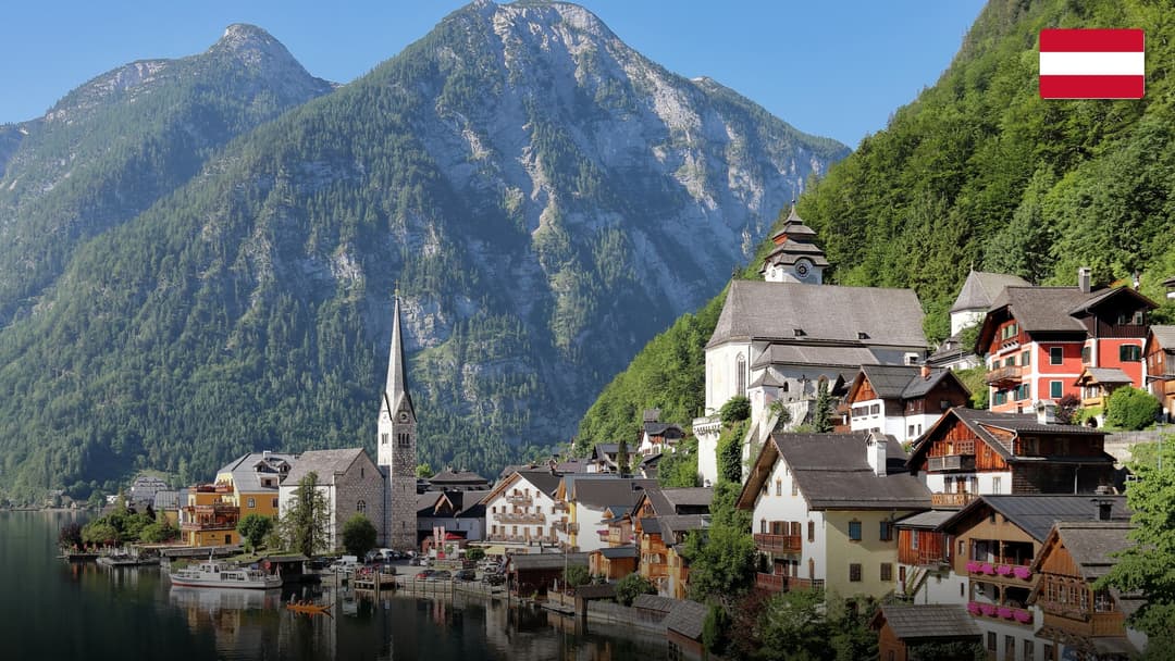 Postcard-perfect alpine village of Hallstatt nestled against a crystal lake and steep mountains.