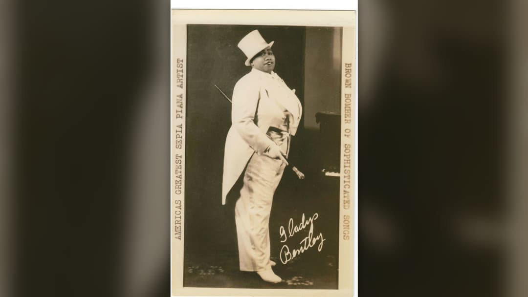 Blues singer Gladys Bentley posing in tuxedo and top hat