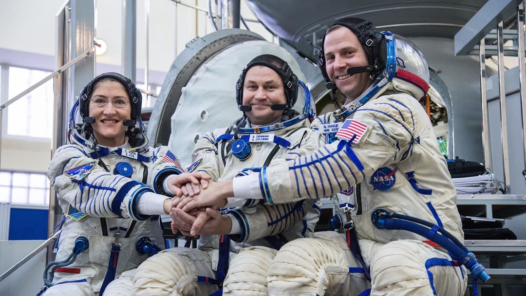 NASA astronaut Christina Koch and crewmates in front of the Soyuz spacecraft simulator at Star City in Russia