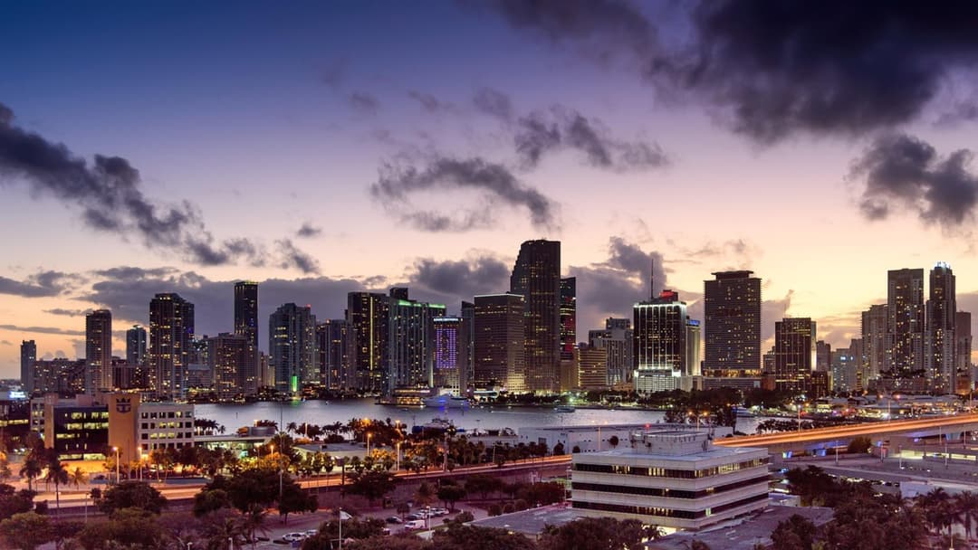 Panoramic sunset view across Biscayne Bay and the Miami waterfront skyline