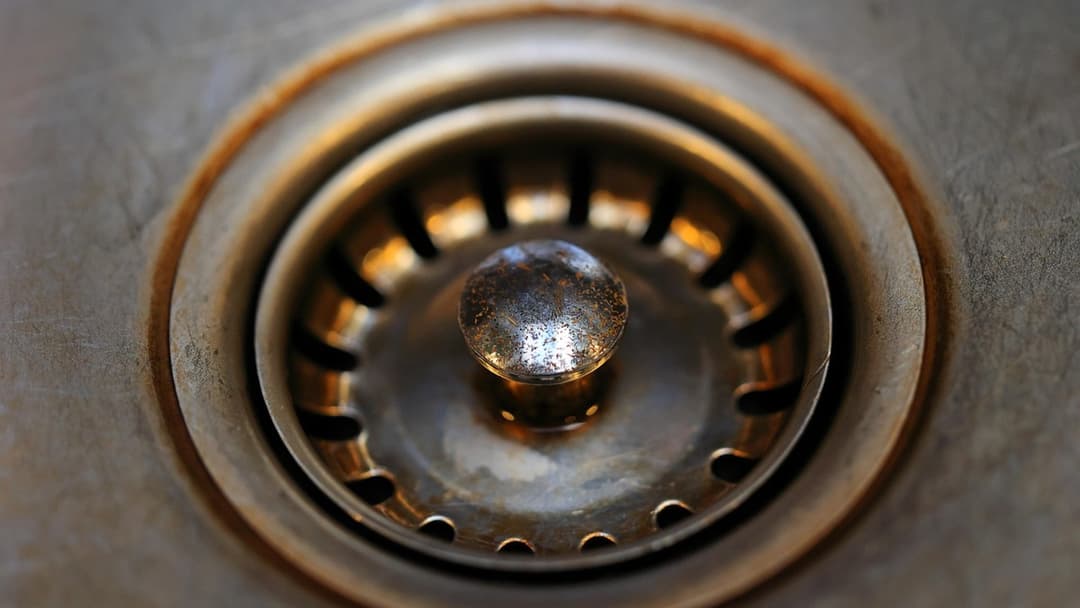 Close up view of a metal bathroom drain strainer