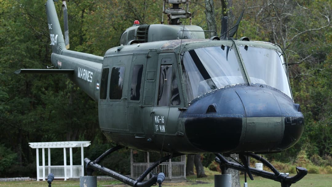 Bell UH-1 Iroquois Huey utility helicopter flying with open side doors at the Sioux Falls Air Show