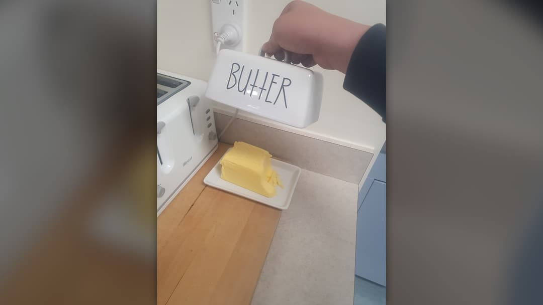Block of fresh creamy butter served in a butter dish