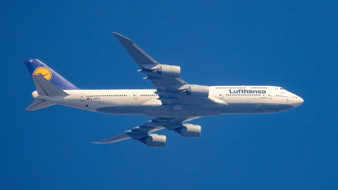 Wide side profile of a Boeing 747-8 wide-body commercial airliner in flight