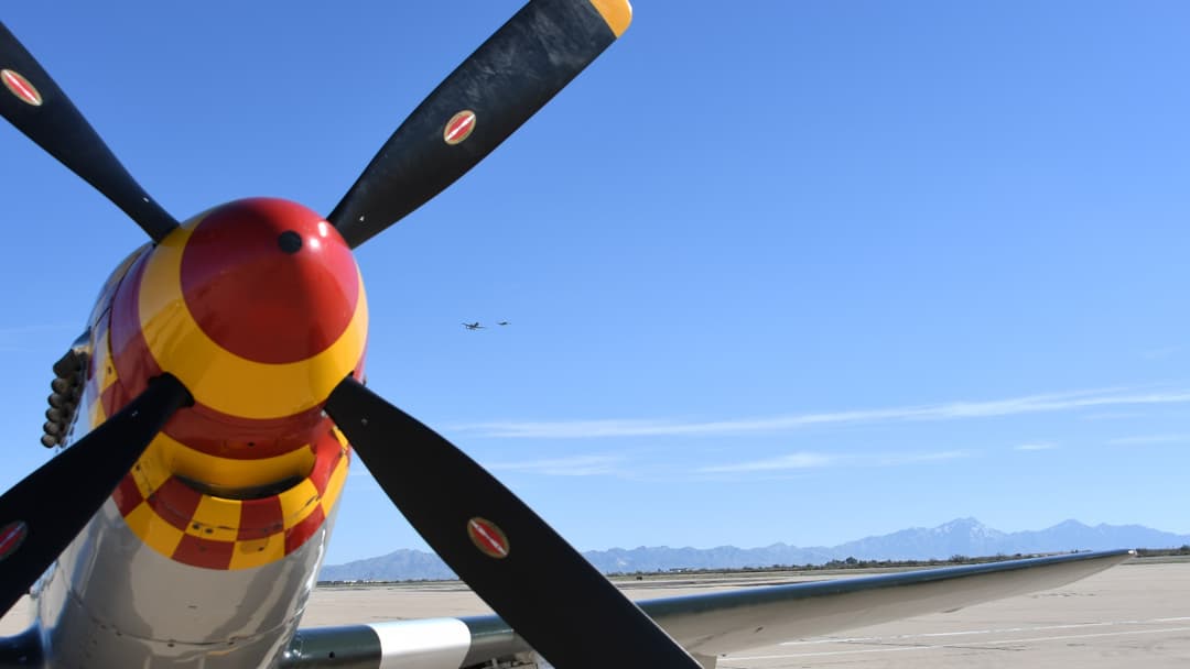Curtiss P-40 Warhawk WWII fighter plane with shark mouth nose art in flight during Heritage Flight training