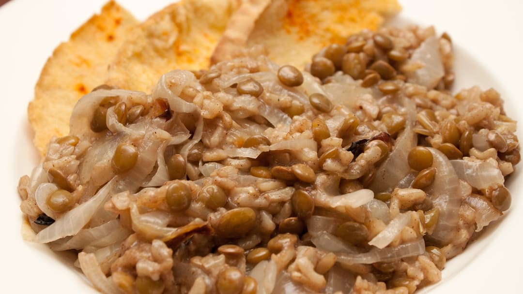 Bowl of cooked lentils and brown rice with spices