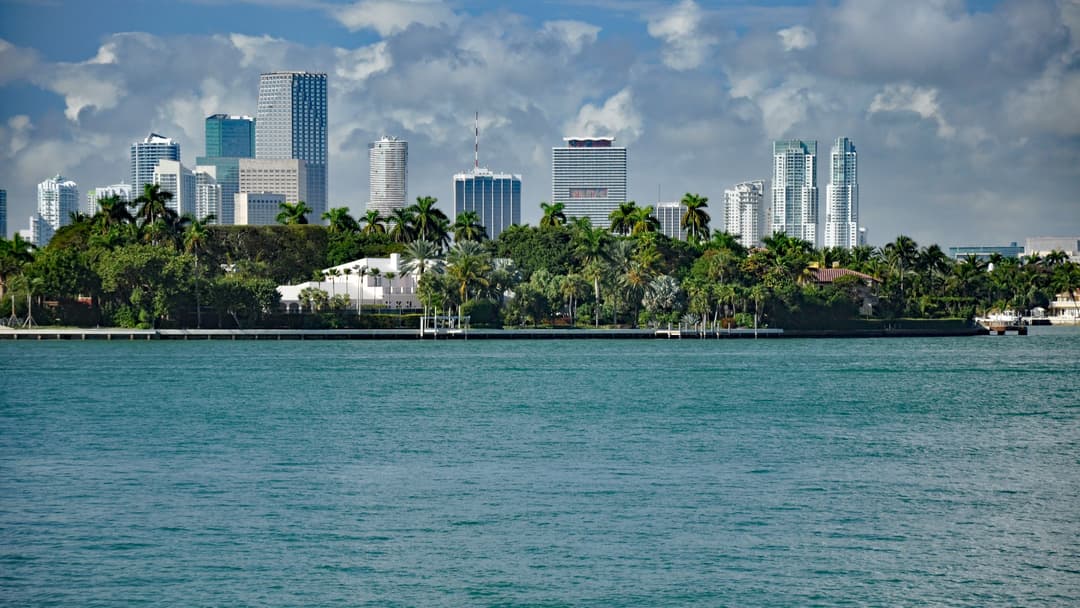 Daytime view of the Miami Florida city skyline across the blue waters of Biscayne Bay