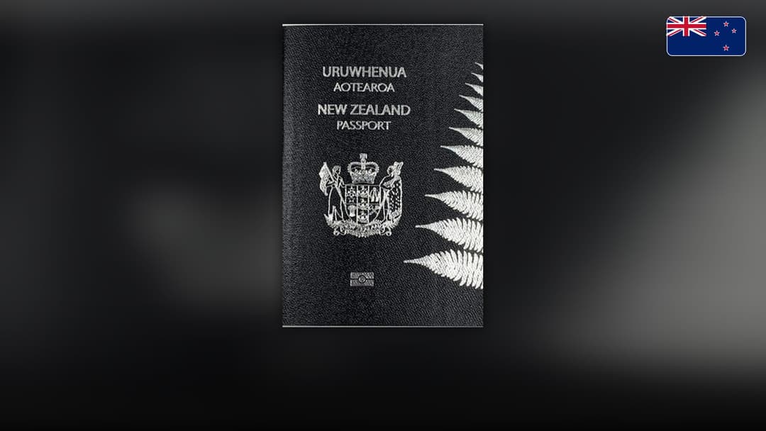 Distinctive black New Zealand passport cover embossed with silver ferns and national crest.