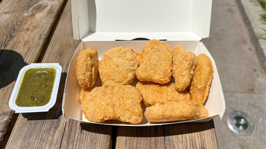 Box of golden Chicken McNuggets served with dipping sauce