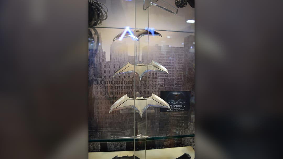 Pair of machined metal Batman Batarang throwing blades on display