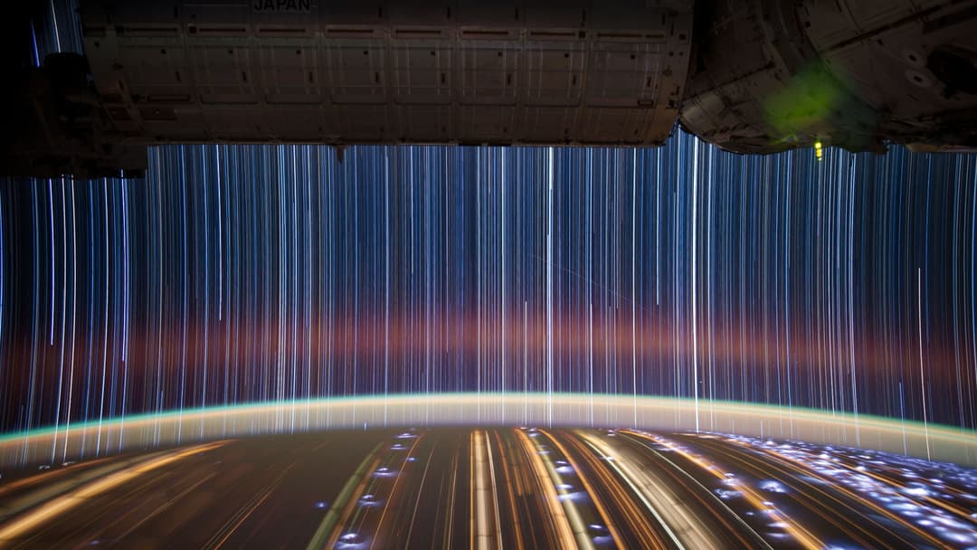 Long-exposure star trails and deep space darkness photographed from the International Space Station