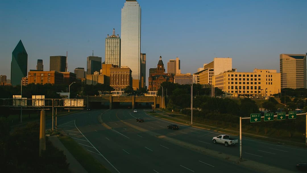 Dallas skyline in the evening with illuminated skyscrapers.