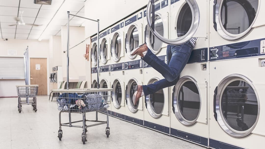 Laundry basket in front of a row of washing machines