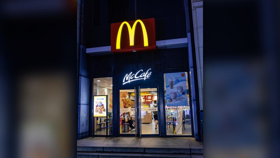 McDonald's restaurant storefront and illuminated golden arches signage