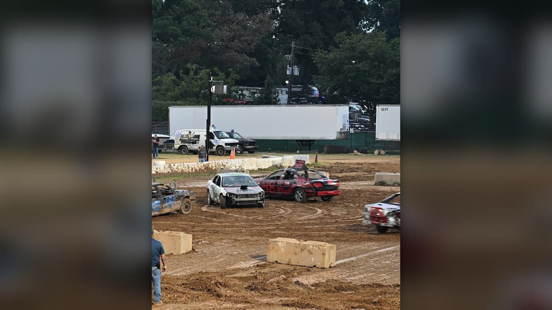 Spray-painted sedans crashing in a muddy arena at the Montgomery County Fair Demolition Derby in Maryland