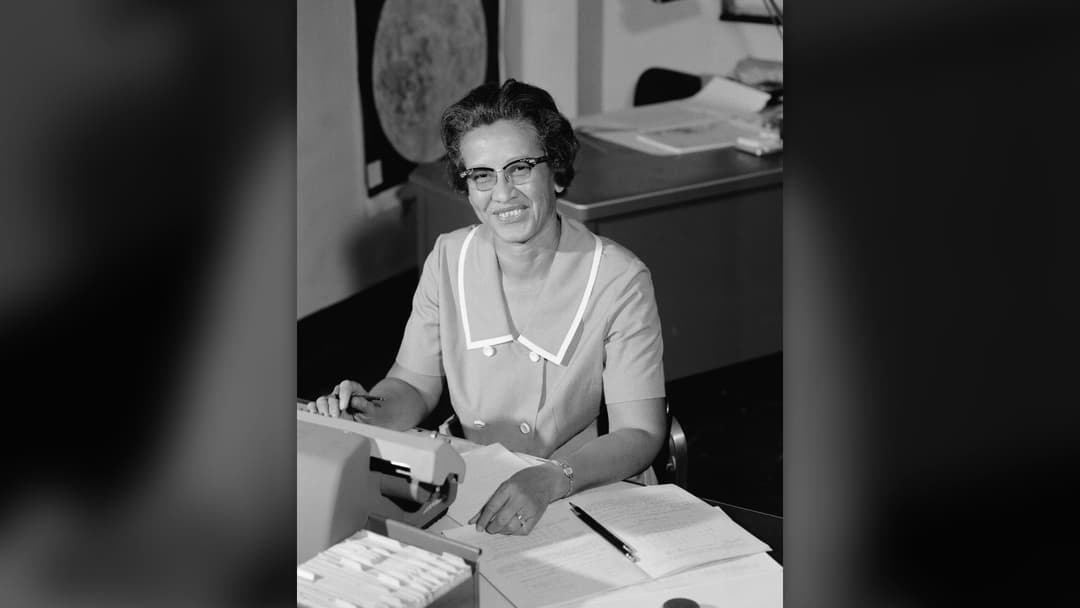 NASA mathematician Katherine Johnson seated at her desk in 1966