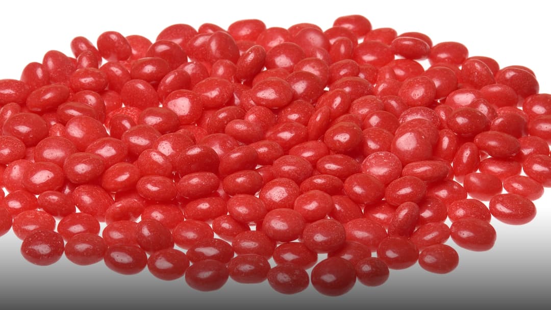Box and spicy red cinnamon candies.