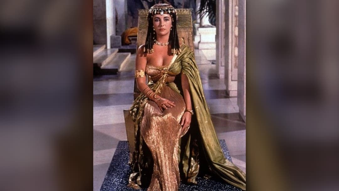 Elizabeth Taylor posing in royal golden Cleopatra headdress