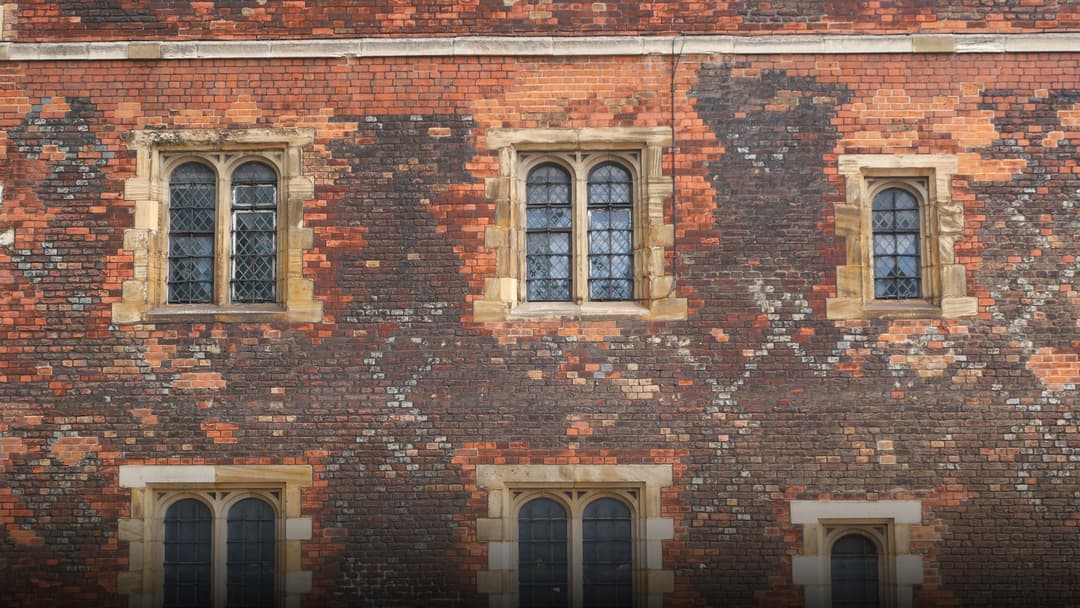 The historic red-brick Tudor gatehouse and towers of Lambeth Palace along the River Thames in London.