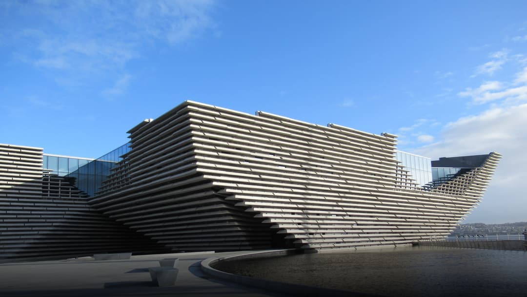 The striking modern architectural facade of the V&A Dundee design museum on the River Tay waterfront.