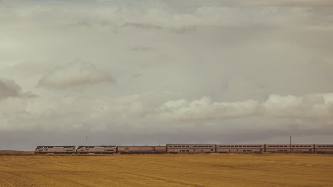 Amtrak's Empire Builder train traveling across the open plains of northern Montana.