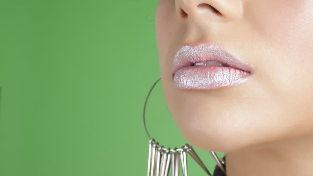 Close-up of frosted bubblegum-pink Barbie doll lips and sculpted nose tip