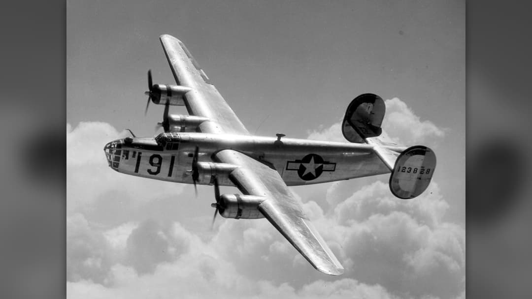 Four-engine Consolidated B-24 Liberator WWII heavy bomber flying over clouds