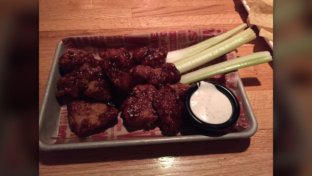 Crispy golden buffalo wings served with creamy dipping sauce and celery
