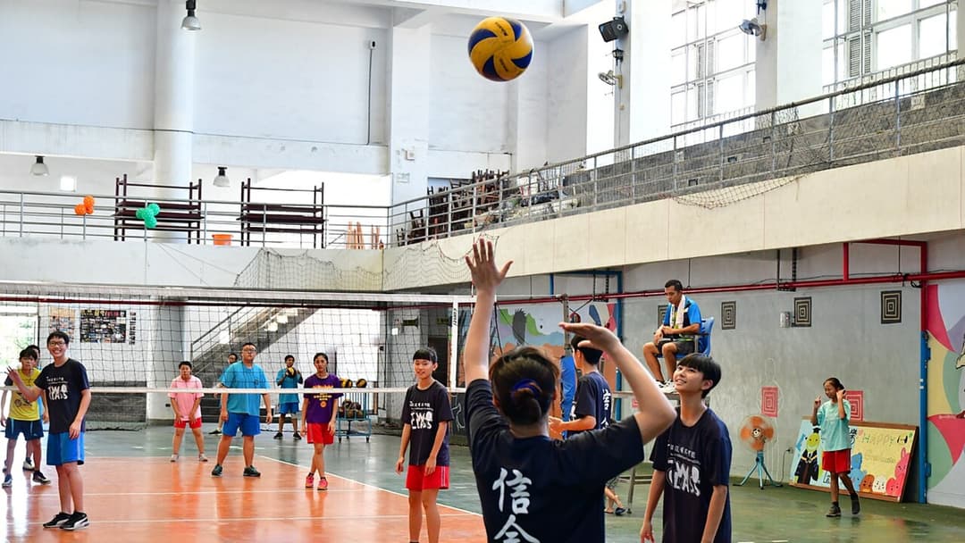 Volleyball players competing during a fast-paced indoor match