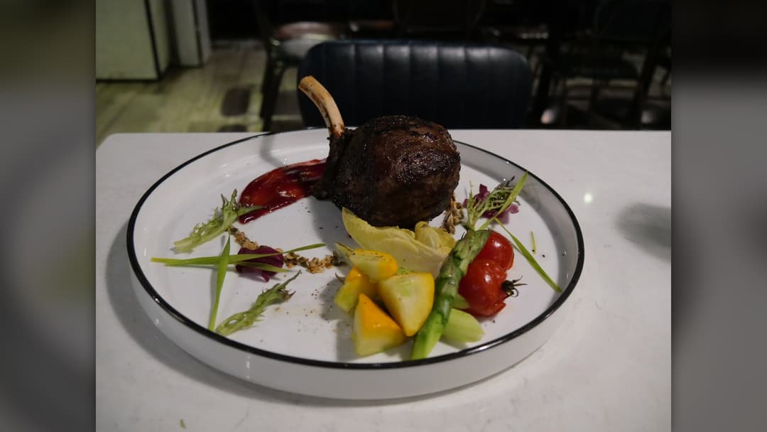 Seared venison steak served with roasted root vegetables on a plate