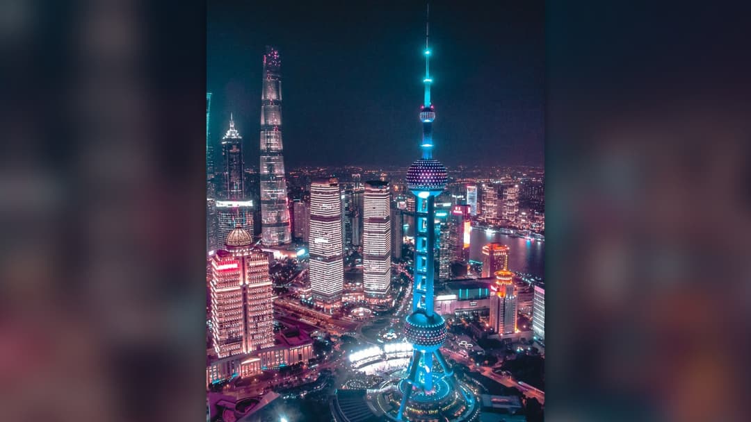 Shanghai Pudong financial district skyscrapers illuminated across the river
