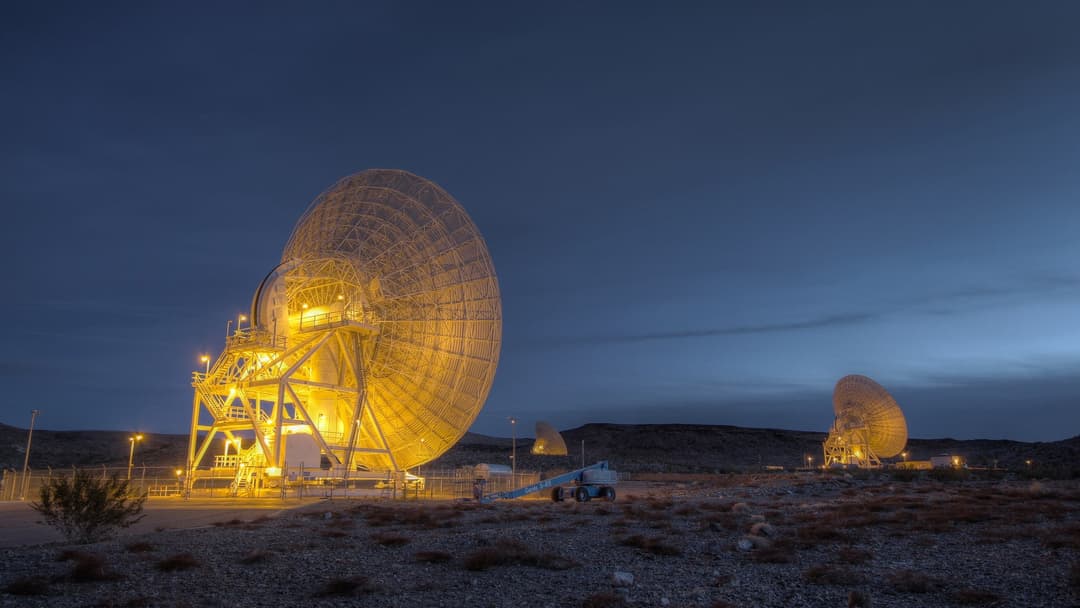 Giant planetary radar dish antenna at the Goldstone Deep Space Communications Complex at dawn
