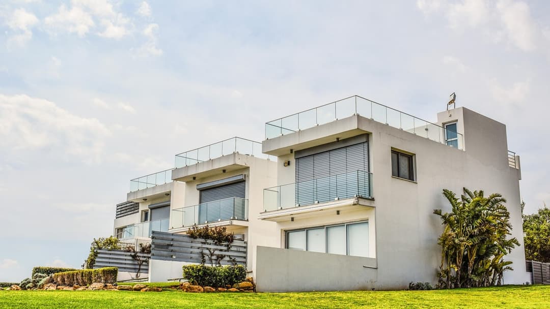 Newly built modern white luxury spec residence with swimming pool and palm trees
